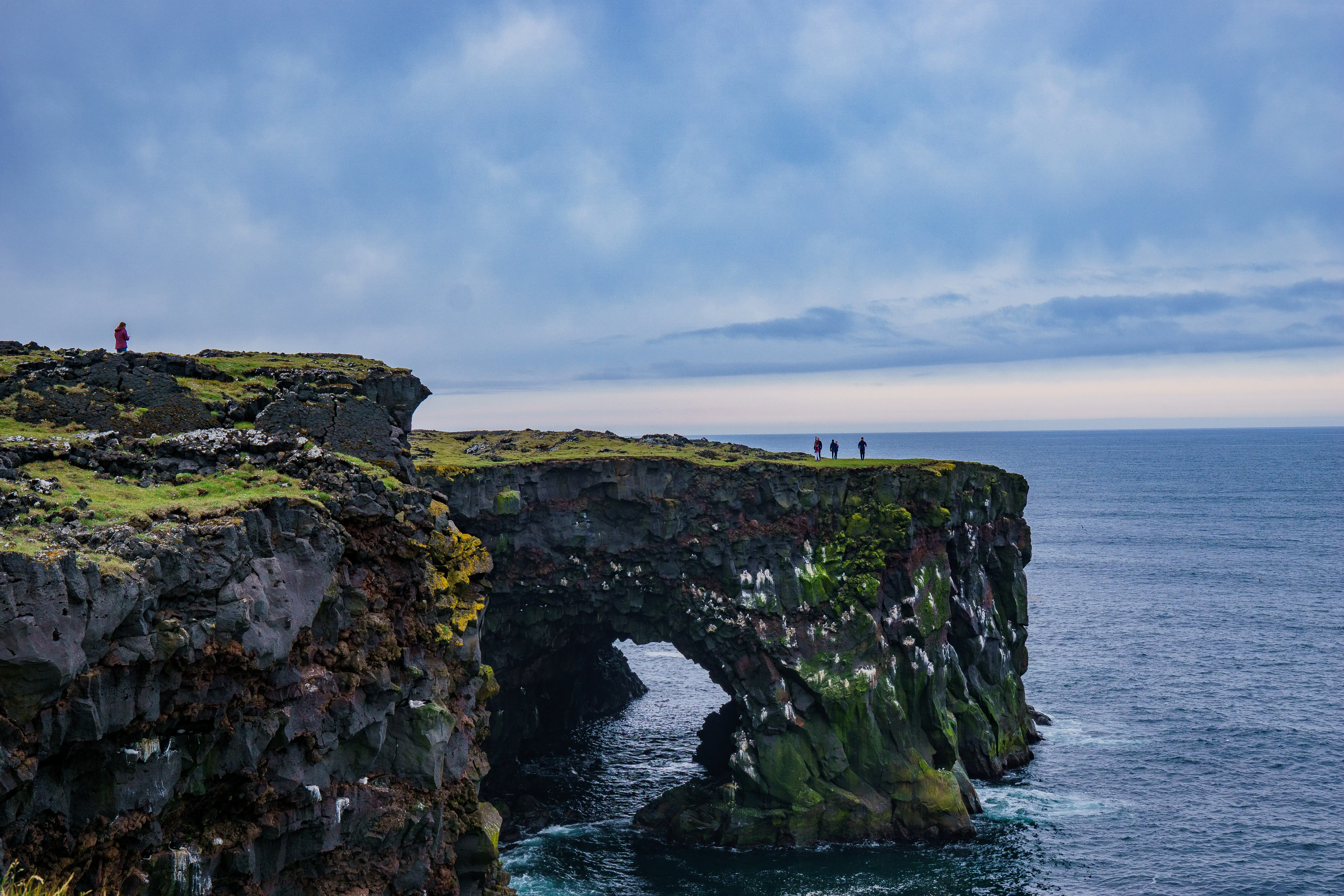 Rock sea arch and cliffs along the Icelandic coast.
